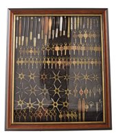 Lot 1 - Small wall display cabinet containing various watch maker's tools and keys