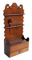 Lot 381 - George III oak spoon rack.