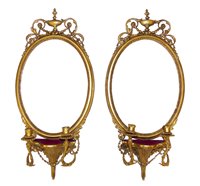 Lot 364 - A pair of Regency Gesso framed oval Girandole wall mirrors.
