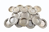 Lot 12 - Eighteen 18th and 19th century pewter side-plates with various unidentified touchmarks, including London touchmarks.