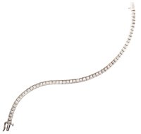 Lot 115 - 18ct white gold diamond set line bracelet