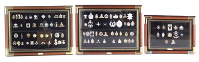 Lot 202 - Ninety two British Army and Police cap badges in three framed sets.