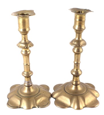 Lot 159 - A pair of petal base brass candlesticks.