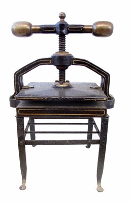 Lot 158 - Cast iron book press and footman.
