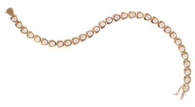 Lot 76 - An 18ct yellow gold diamond set line (tennis) bracelet.
