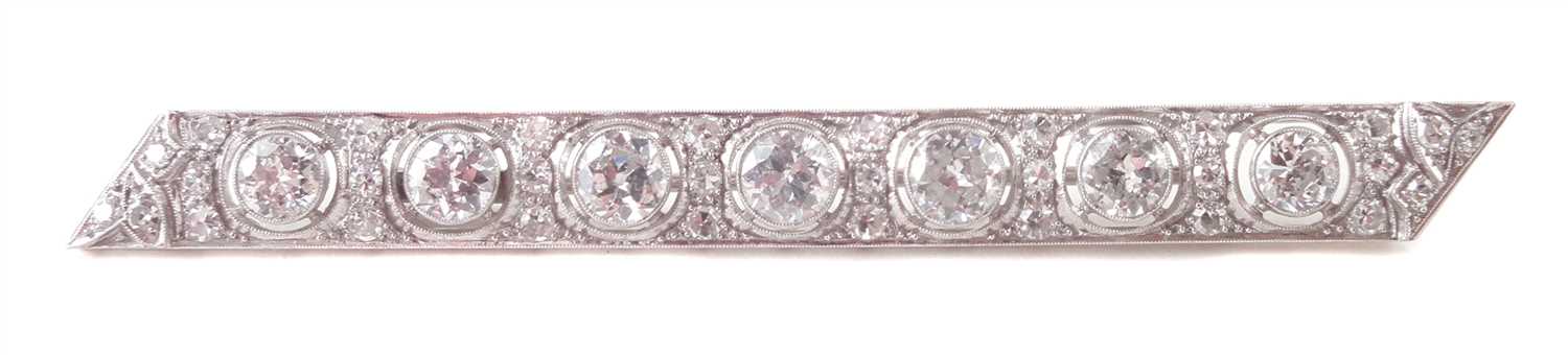 Lot 81 - A diamond set platinum bar brooch.