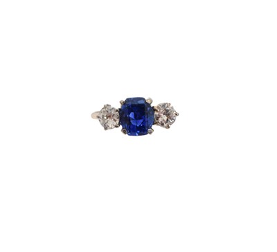 Lot 235 - An 18ct gold Sri Lankan sapphire and diamond three stone ring