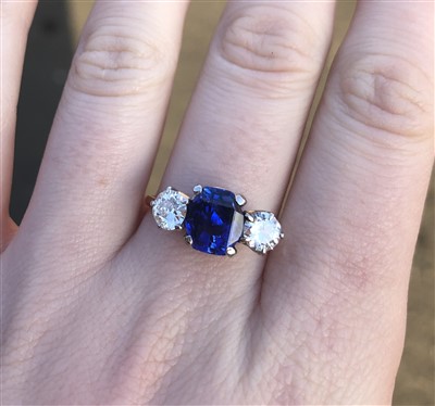 Lot 235 - An 18ct gold Sri Lankan sapphire and diamond three stone ring