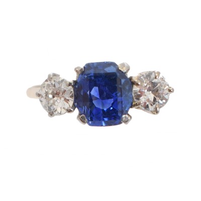 Lot 235 - An 18ct gold Sri Lankan sapphire and diamond three stone ring