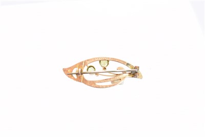Lot 38 - An early 20th century Murrle Bennett & Co. peridot and split pearl brooch