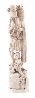 Lot 371 - Japanese ivory fisherman with boy on rock