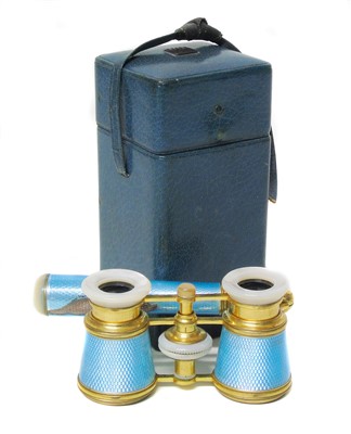 Lot 321 - A pair of gilt metal and blue enamelled opera glasses marked Asprey.