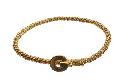 Lot 75 - A 9ct gold initial bangle