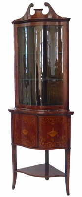 Lot 326 - Edwardian mahogany double floor standing serpentine front display cabinet