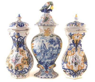 Lot 252 - Pair of hexagonal lidded tin glazed vases and one other Delft vase.