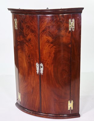 Lot 386 - George III mahogany corner cupboard