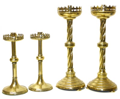 Lot 115 - A pair of Victorian brass gothic design candlesticks