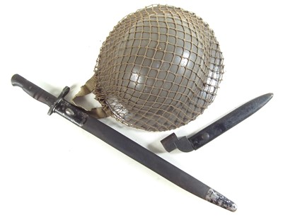 Lot 401 - Two bayonets and a helmet