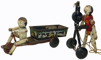 Lot 218 - Hustler Toy Corporation tin plate toy wooden figure peddling a tricycle etc.