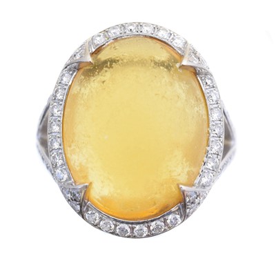 Lot 79 - An 18ct gold amber and diamond cluster ring