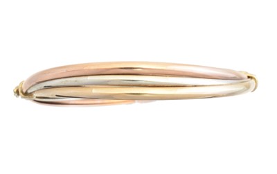 Lot 6 - A 9ct gold tri-colour hinged bangle