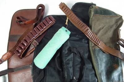 Lot 340 - Five gun slips, two cartridge belts, a sling and a gun dog training dummy