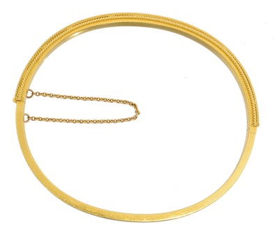 Lot 24 - A Victorian Etruscan Revival hinged bangle