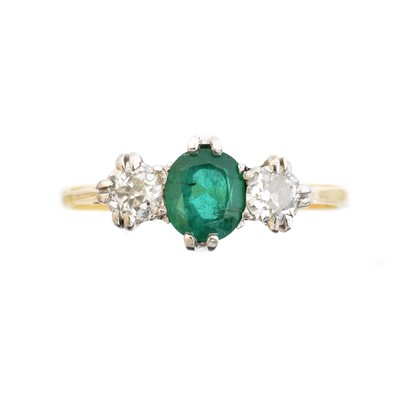 Lot 64 - An 18ct gold emerald and diamond three stone ring