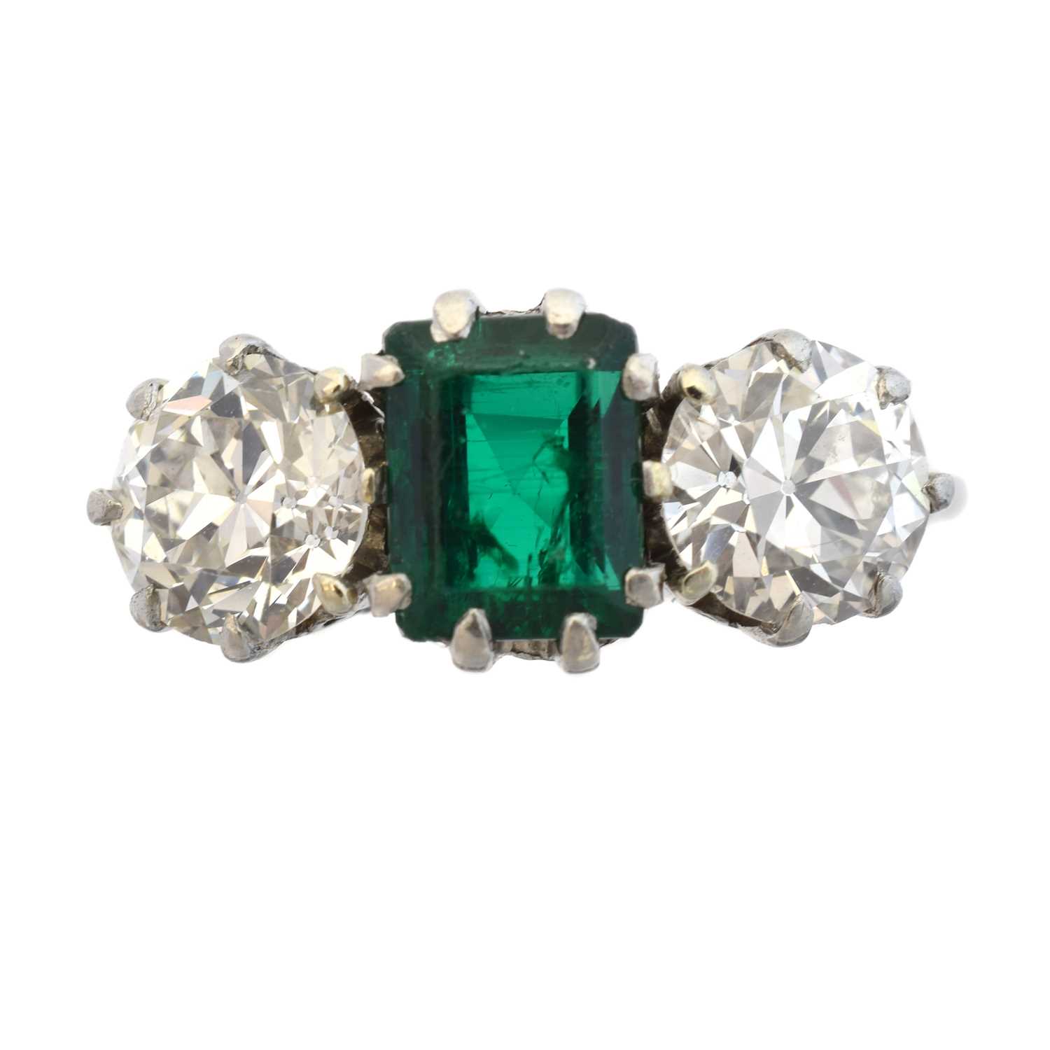 Lot 163 - An emerald and diamond three stone ring