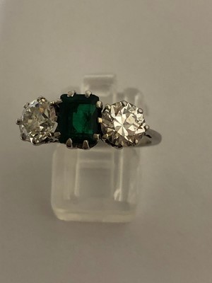Lot 163 - An emerald and diamond three stone ring