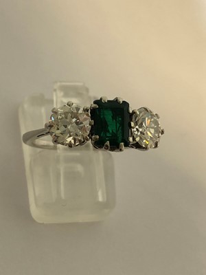 Lot 163 - An emerald and diamond three stone ring