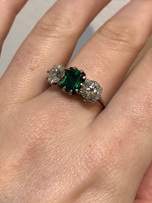 Lot 163 - An emerald and diamond three stone ring