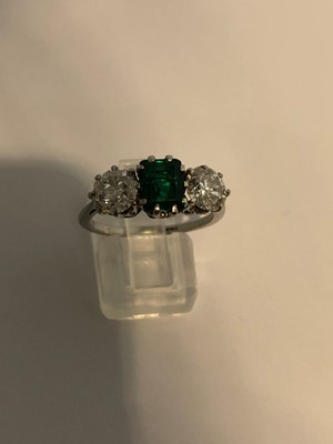Lot 163 - An emerald and diamond three stone ring