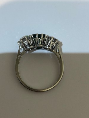 Lot 163 - An emerald and diamond three stone ring
