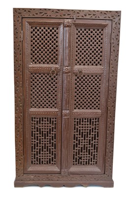 Lot 250 - Early 20th-century Indian brown painted heavily carved food cupboard