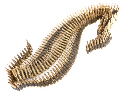 Lot 356 - Three metres of fired 7.62mm blank cartridges in GPMG break link