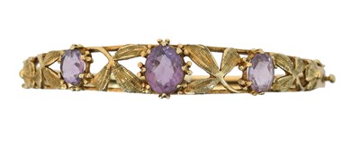 Lot 47 - A 9ct gold amethyst hinged bangle