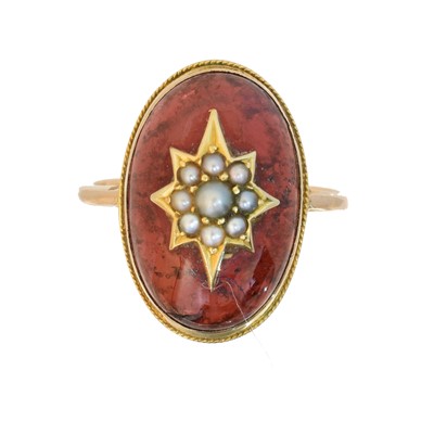 Lot 130 - A garnet and split pearl dress ring