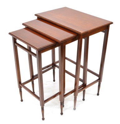 Lot 344 - Mid 20th century nest of three mahogany tables