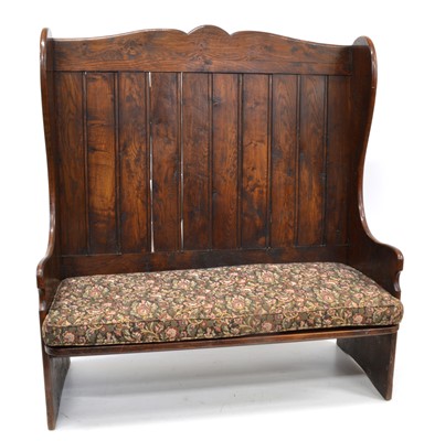 Lot 286 - Late 19th century oak wingback tavern settle