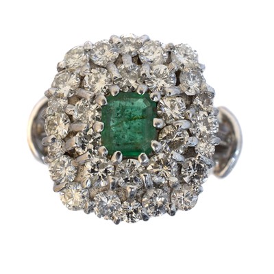 Lot 145 - An emerald and diamond cluster ring.