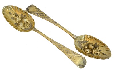 Lot 119 - A pair of George III silver gilt berry spoons