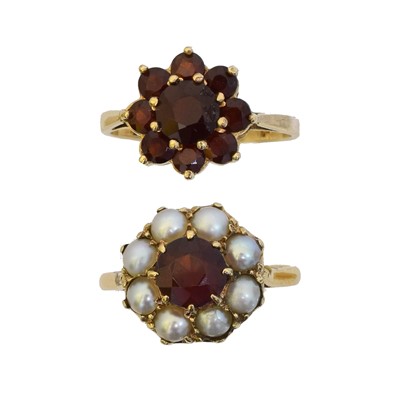 Lot 83 - Two garnet dress rings.