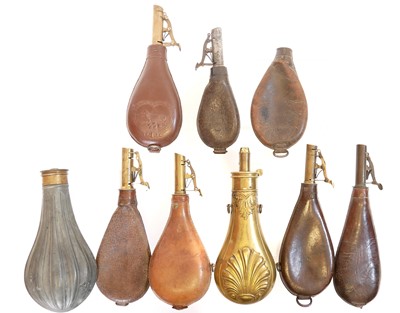 Lot 473 - Six leather and brass shot flasks, one of...