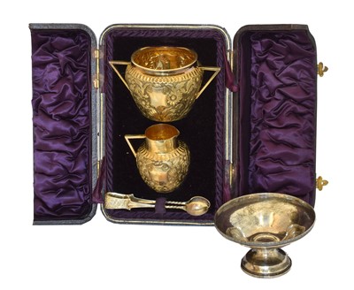 Lot 168 - A Victorian cased silver gilt sugar bowl, milk jug and tongs