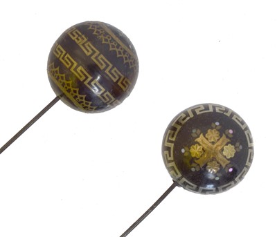 Lot 171 - Two 19th century tortoisehell inlaid hat pins.