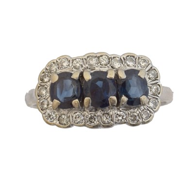 Lot 167 - A sapphire and diamond cluster ring.