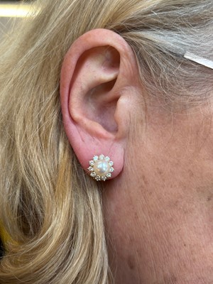 Lot 53 - A pair of cultured pearl and diamond earrings by Mikimoto.