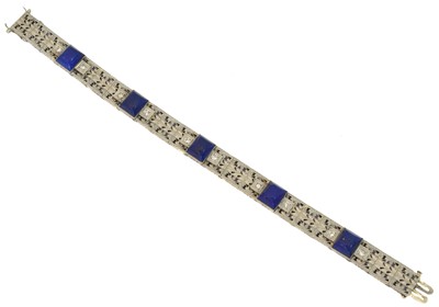 Lot 28 - An early 20th century lapis lazuli and diamond panel bracelet.