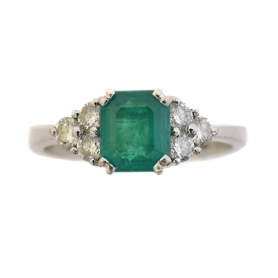 Lot 137 - An 18ct gold emerald and diamond dress ring.